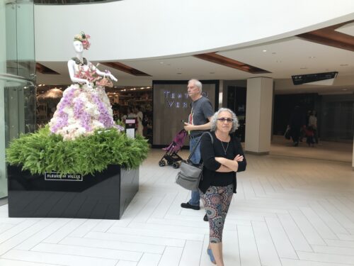 Ellen Lewinberg looking at dresses made from plants and flowers