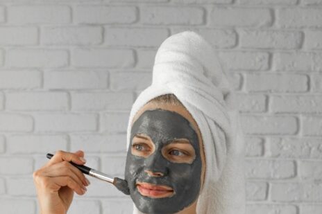 FREEPIK - woman applying a charcoal mask to her face.